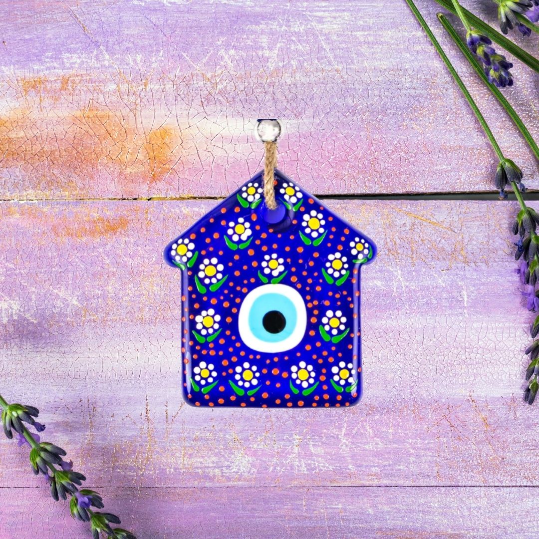 Evil eye bead in the form of a decorative house.